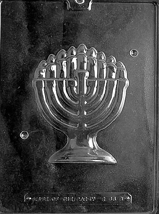 Clear plastic chocolate mold showing the matching half of a menorah design with raised candle details and rounded base, designed to pair for a complete freestanding 3D chocolate menorah.