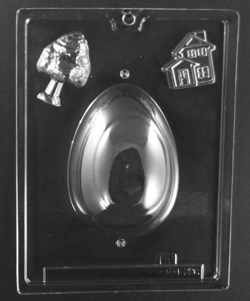 Clear plastic chocolate mold showing the matching egg-shaped cavity half with additional small bonus figure cavities, including a tree shape and a small house design.
