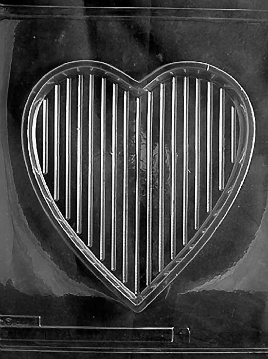 Clear plastic mold showing a large heart-shaped chocolate box base with vertical grooves, designed to pair with embossed heart-shaped lids.
