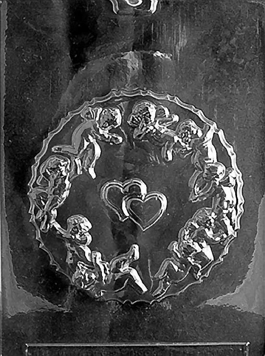Clear plastic mold featuring a round chocolate box lid design embossed with cherubic Cupids encircling two hearts in the center.