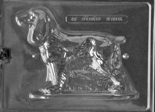 Clear plastic chocolate mold showing the front half of a standing Springer Spaniel with floppy ears, textured coat detail, and defined legs on a base edge.