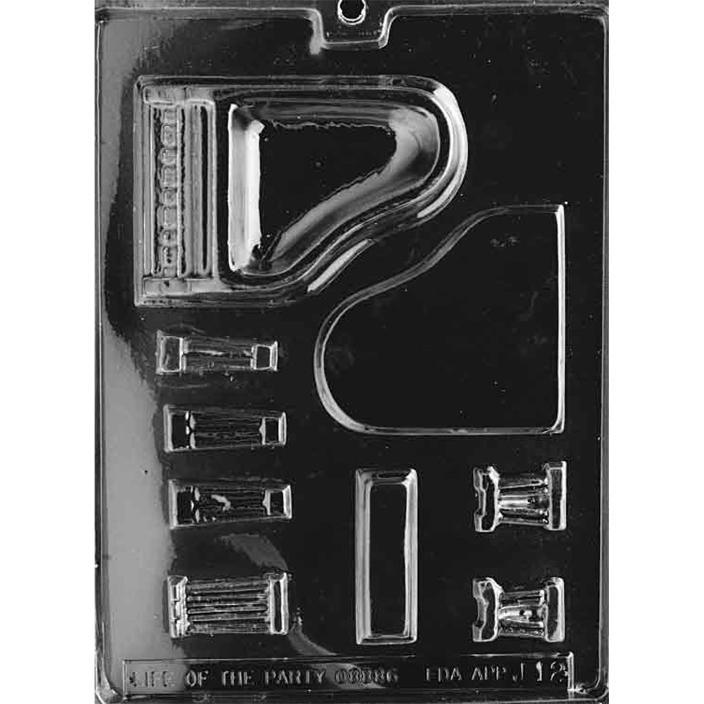 Clear plastic chocolate mold with multiple cavities for assembling a 3D grand piano, including the piano body, curved lid, keyboard detail, and smaller accessory pieces.