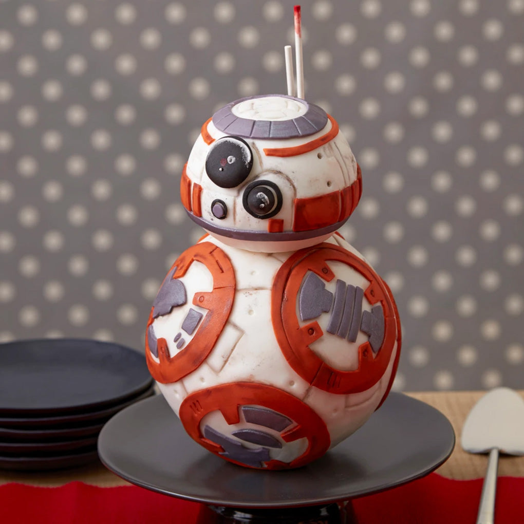 Orange and white 3D droid cake made from stacked round cakes baked in the Wilton Ball Cake Pan Set