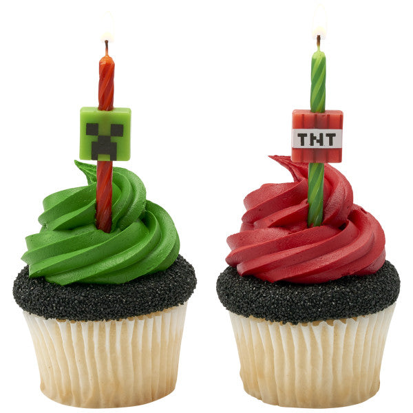 Cupcakes topped with Minecraft Creeper and TNT birthday candles, ready for a themed celebration.