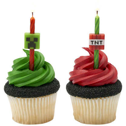 Cupcakes topped with Minecraft Creeper and TNT birthday candles, ready for a themed celebration.