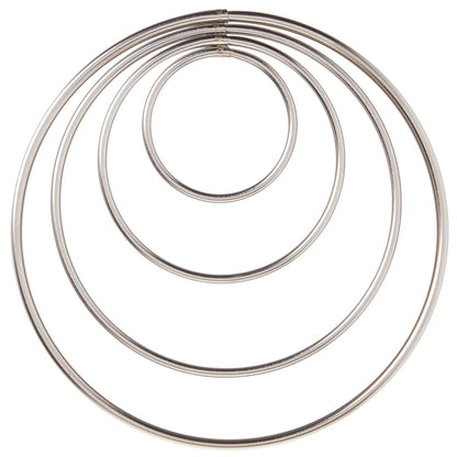 Top-down view of four round cutters nested concentrically, forming a target-like set of circles on a white background.