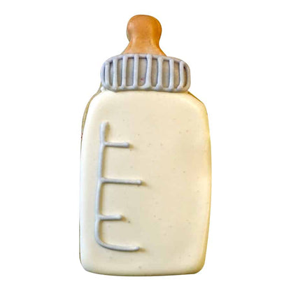 Baby bottle cookie with cream-colored icing and gray and brown details, showcasing a realistic bottle design.