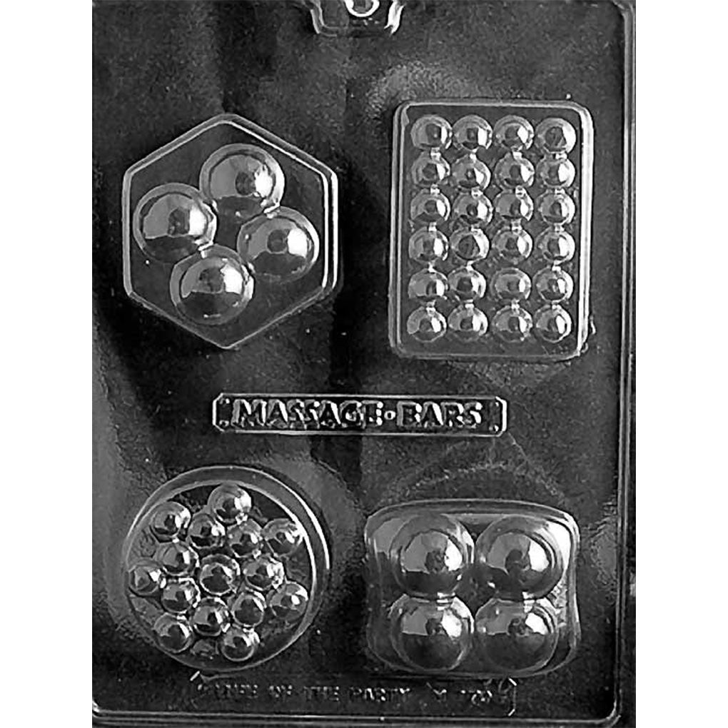 Clear chocolate mold with four assorted massage bar-inspired cavities: a hexagon with four large bumps, a rectangle with rows of small bumps, a round clustered design, and a rounded square with four large bumps.
