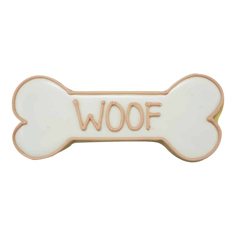 Dog bone-shaped cookie decorated with white icing and the word 'WOOF' piped in brown.