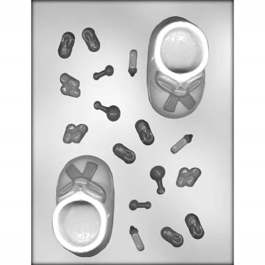 Clear plastic chocolate mold with two large cavities shaped like baby booties with ribbon details and several smaller cavities featuring baby-themed items such as bottles, rattles, and safety pins.