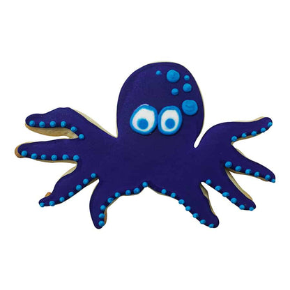 Blue octopus cookie with blue and white polka dots and expressive eyes.