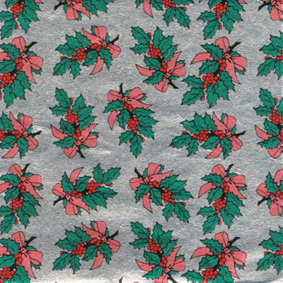 Decorative foil wrapping paper with a holly and berry design on a silver background.