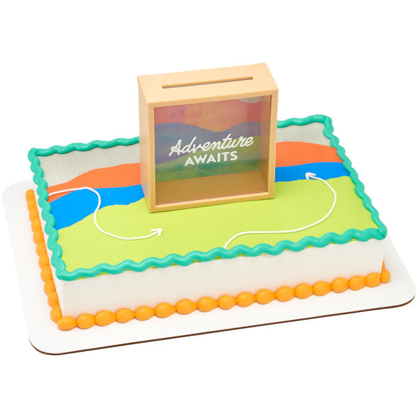 Rectangular cake decorated with a scenic adventure-themed design, featuring the Adventure Awaits memory box topper.