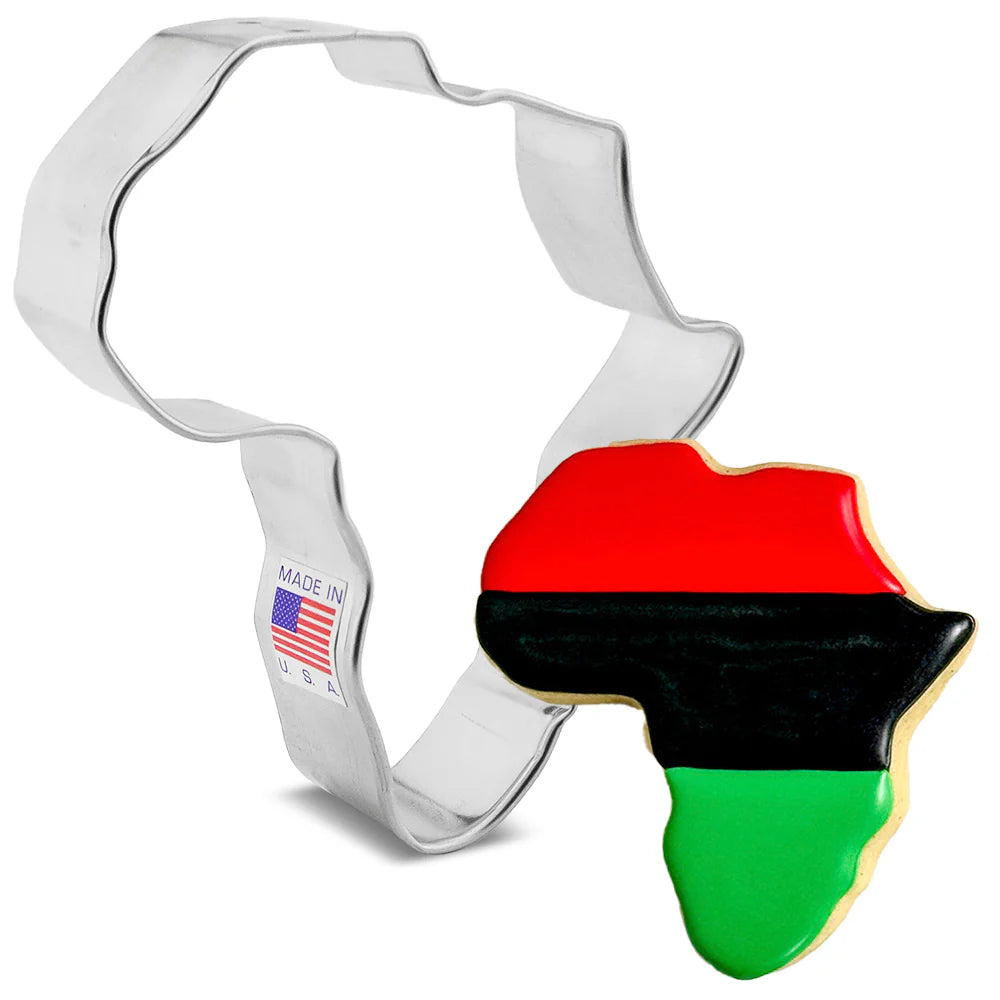 Silver Africa-shaped cookie cutter next to a decorated Africa-shaped cookie with red, black, and green horizontal icing stripes on a white background.
