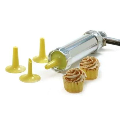 Cookie press fitted with an icing tip, with two mini cupcakes decorated with piped frosting.