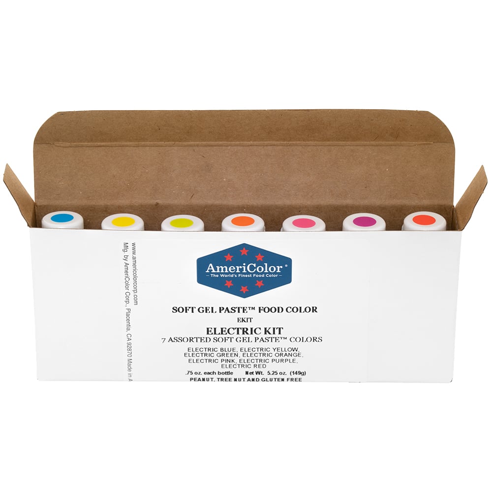 AmeriColor Electric Kit open box displaying seven Soft Gel Paste bottles with color-coded caps in electric shades of blue, yellow, green, orange, pink, purple, and red.