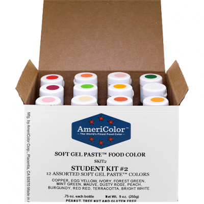 Open box of AmeriColor Soft Gel Paste Student Kit showing 12 color-coded bottles arranged neatly inside, labeled with the kit name and included shades.