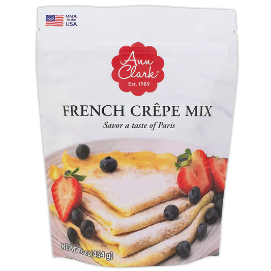 Ann Clark French Crêpe Mix package featuring folded crêpes dusted with powdered sugar and garnished with strawberries and blueberries, ideal for sweet or savory dishes.