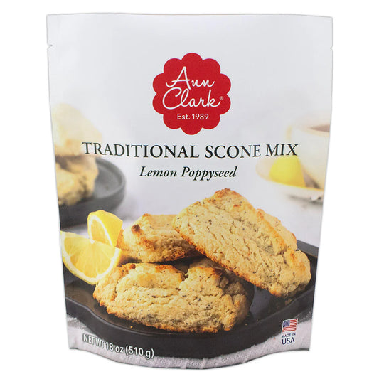 Front of Ann Clark Lemon Poppyseed Traditional Scone Mix bag, featuring a photo of golden scones with lemon wedges on a tray and bold red branding.