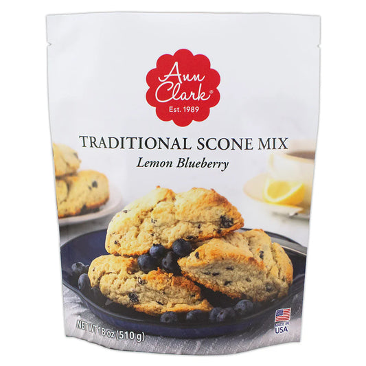 Front of Ann Clark Lemon Blueberry Traditional Scone Mix packaging featuring golden scones with blueberries on a blue plate and lemon slices in background.