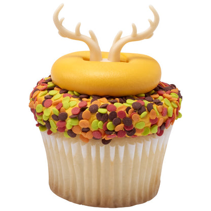 Fall-themed cupcake with yellow fondant and colorful confetti sprinkles, topped with antler ring