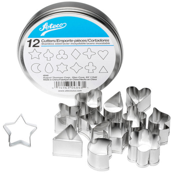 Ateco 4848 12-piece stainless steel aspic cutter set with various small shapes, displayed alongside a round storage tin with labeled packaging.