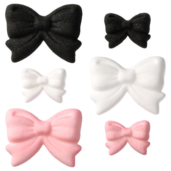 Assorted pressed sugar bow decorations in black, white, and light pink, shown in multiple sizes with sculpted bow folds on a white background.