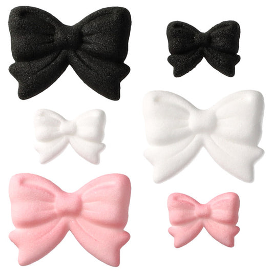 Assorted pressed sugar bow decorations in black, white, and light pink, shown in multiple sizes with sculpted bow folds on a white background.