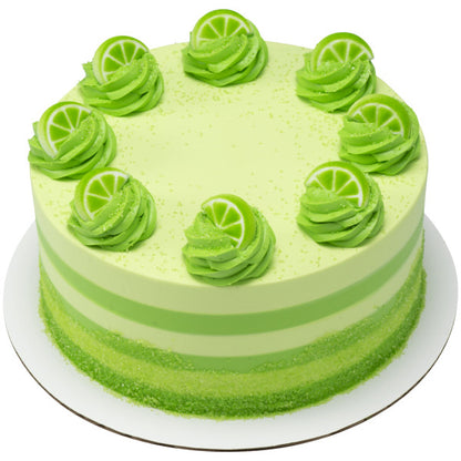 Lime-themed cake decorated with green frosting swirls topped with lime slice sugar decorations.