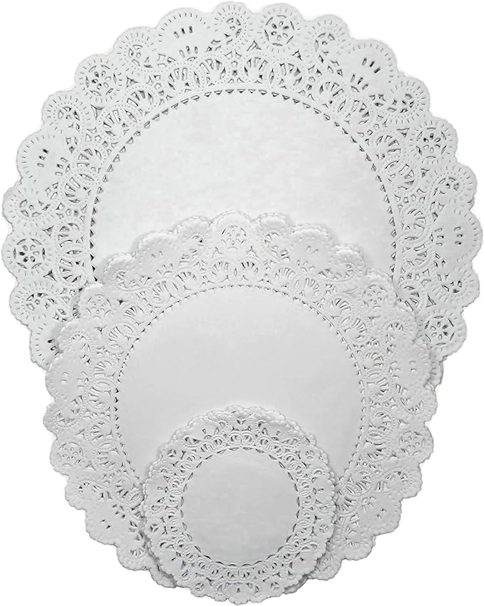 Assorted white paper doilies in various sizes with intricate lace designs.