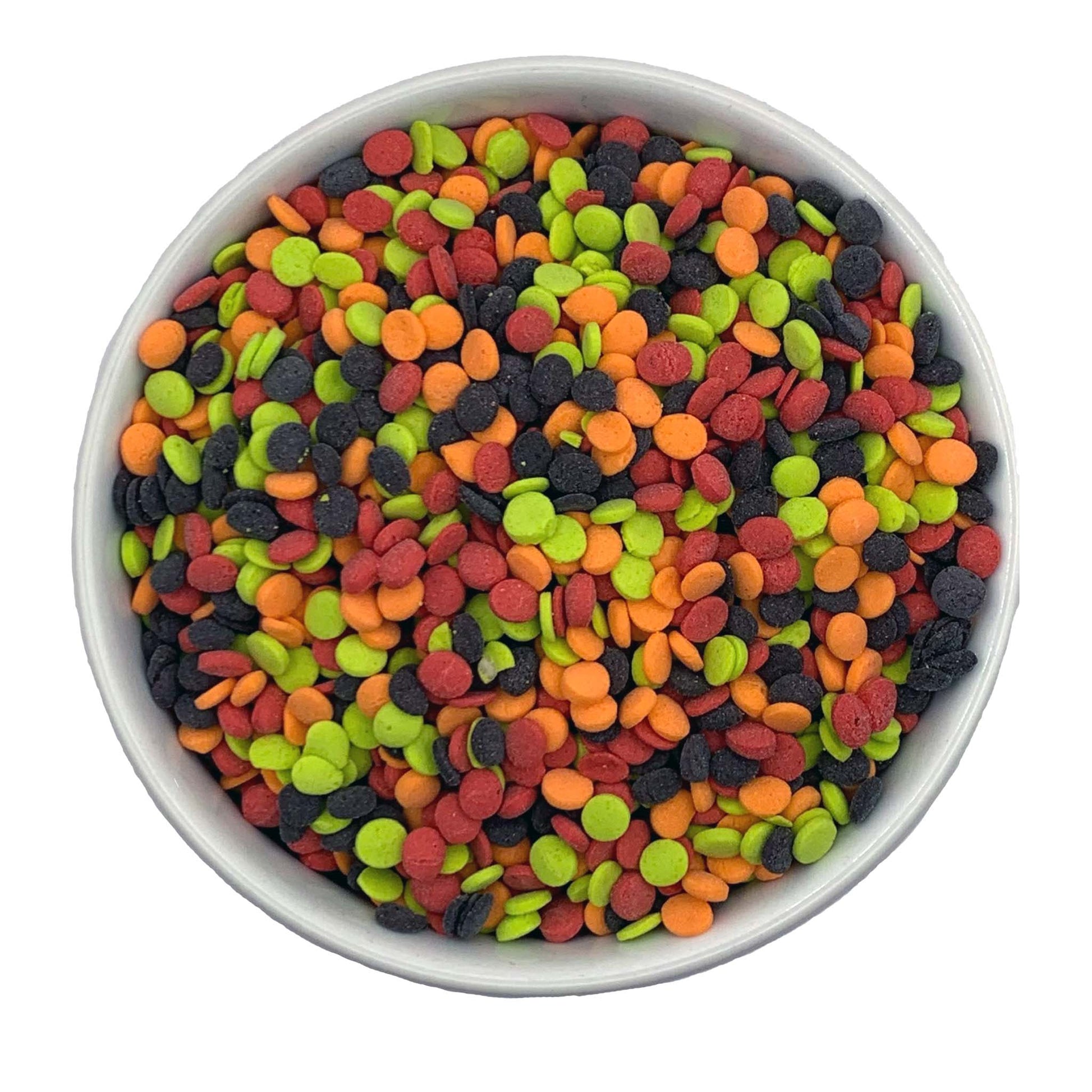 Close-up of a bowl filled with colorful candy sequin sprinkles in red, green, orange, and black.