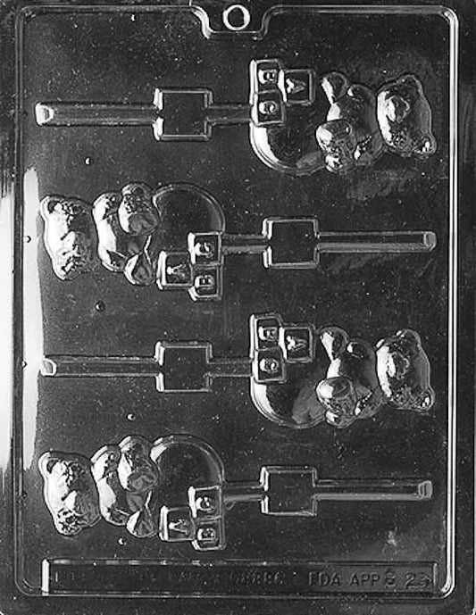 Clear mold with lollipop cavity showing a teddy atop stacked blocks; crisp edges; white backdrop.