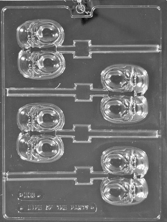 Clear mold cavity shaped like a baby sneaker; laces, sole, and toe cap visible; centered stick groove.