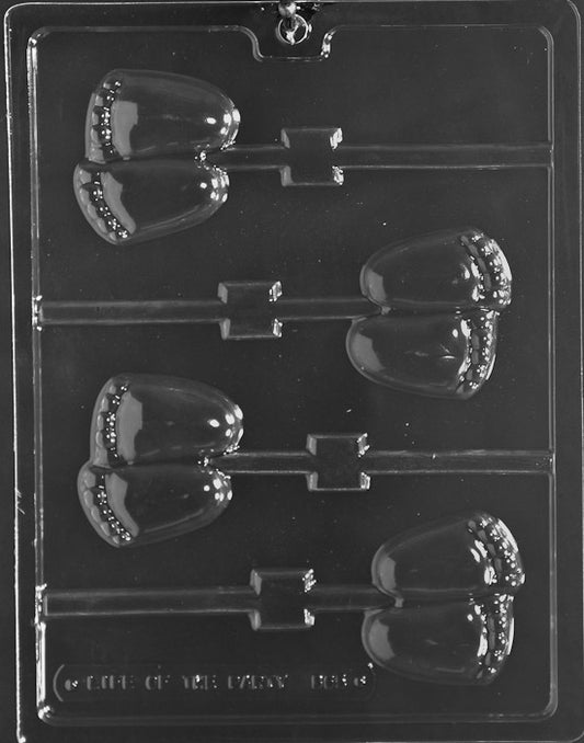 Clear lollipop mold with two baby footprints; rounded toes and arch detail; slim depth; white background.