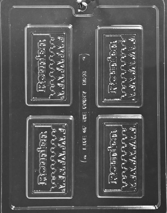 Clear chocolate mold embossed “REUNION”; rectangular plaque with smooth frame; approx. 3.75 x 2.125 in.