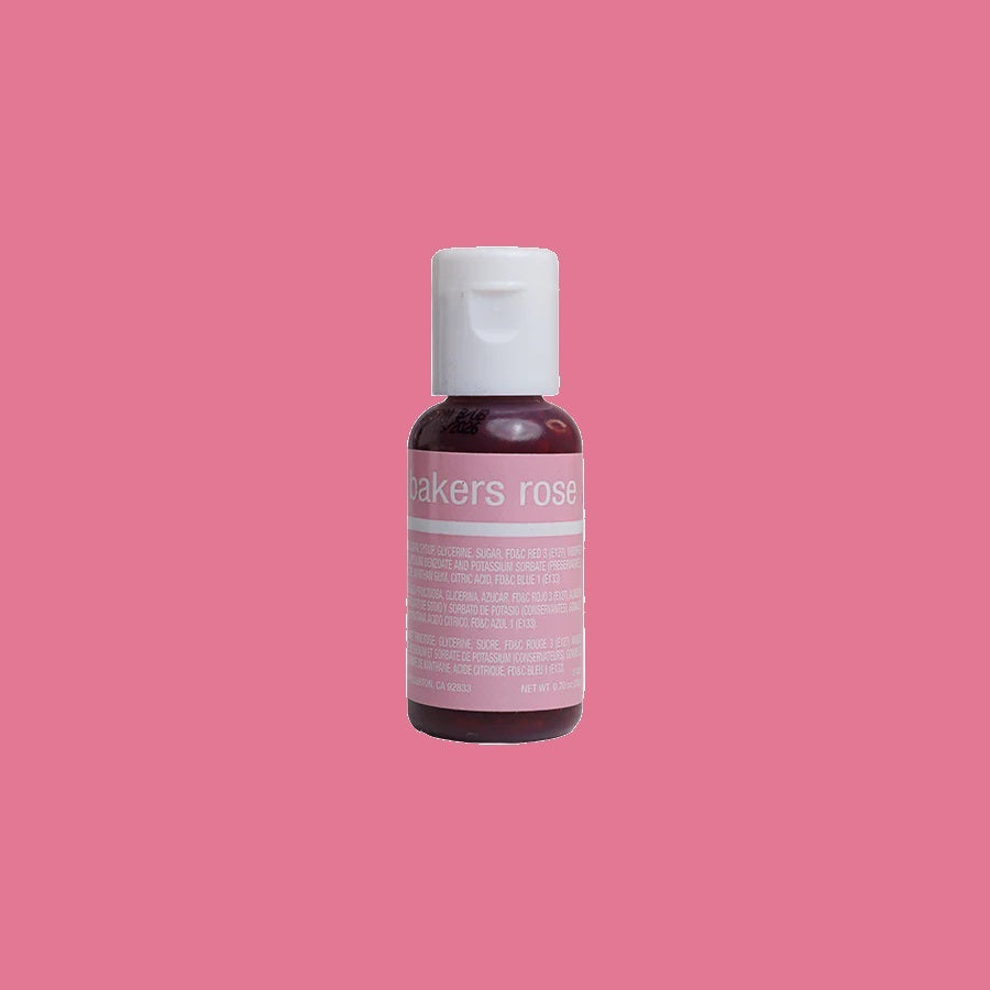 This image features a food coloring bottle with a soft pink hue, labeled "baker's rose". The white cap sits atop a dark pink bottle, with a label that lists the ingredients and details in white text on a background tinted to match the gel's rosy color inside.