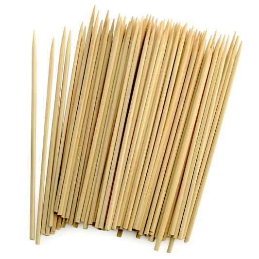Close-up of a large bundle of 6-inch bamboo skewers, showing pointed tips and natural wood texture.