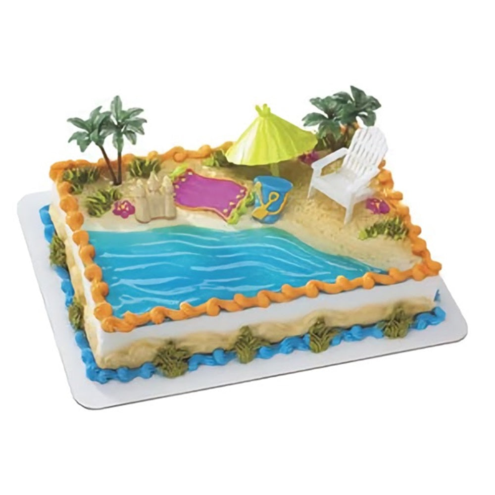Beach chair and umbrella cake decorating kit with a vibrant beach scene, complete with a sand-colored base and blue water detailing for a summer or vacation-themed cake.