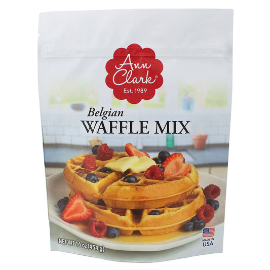 Front of Ann Clark Belgian Waffle Mix package featuring stacked golden waffles topped with butter, syrup, strawberries, blueberries, and raspberries.