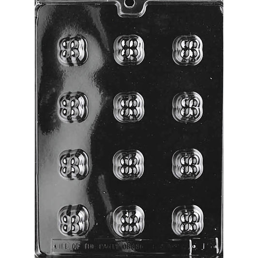 Clear plastic chocolate mold designed for making bite-sized clover-shaped chocolates, featuring twelve compartments arranged in three rows of four. Each compartment is intricately designed to resemble a four-leaf clover with detailed patterns. 
