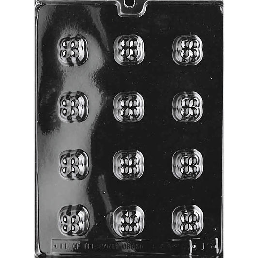 Clear plastic chocolate mold designed for making bite-sized clover-shaped chocolates, featuring twelve compartments arranged in three rows of four. Each compartment is intricately designed to resemble a four-leaf clover with detailed patterns. 
