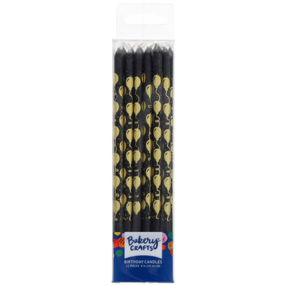 Pack of black birthday candles in a clear plastic box, each candle printed with repeating gold balloons and streamers, labeled “Bakery Crafts Birthday Candles.”