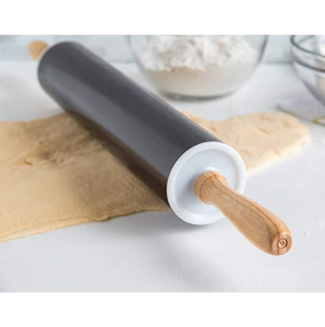 A Black Carbon Rolling Pin on top of some dough being rolled out