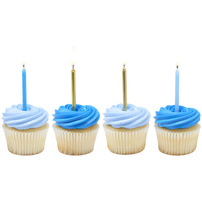 Four cupcakes topped with light blue and dark blue buttercream swirls, each finished with a tall birthday candle in light blue or metallic gold.