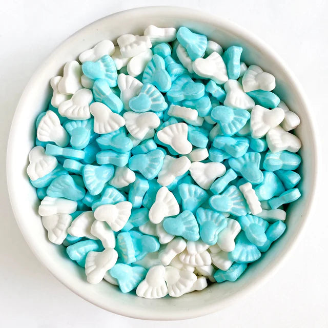 Bowl of blue and white baby bootie sprinkles, perfect for baby showers and gender reveal desserts.