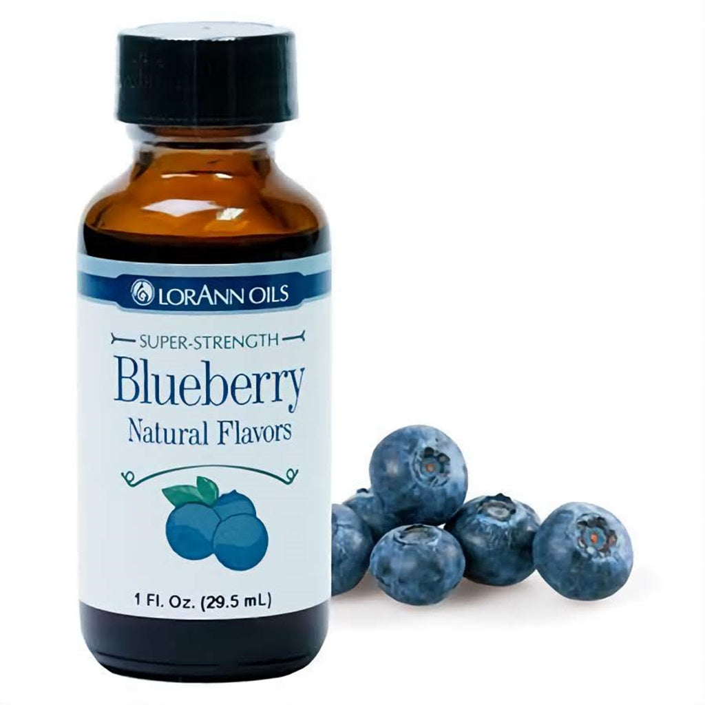 LorAnn Oils Super Strength Blueberry Natural Flavors in a 1 fl oz bottle, with a scattering of fresh blueberries, conveys the genuine blueberry flavor for baking.