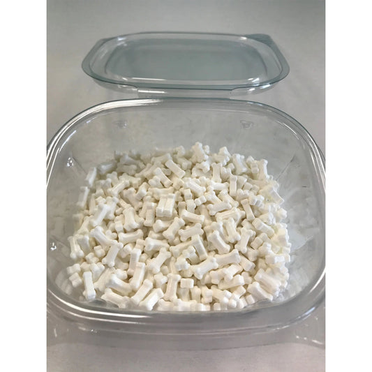 plastic container filled with white bone-shaped sprinkles, with matching lid set behind on a countertop.