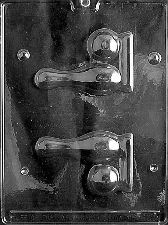 Clear chocolate mold with two sets of bowling designs: a tall pin with a flat base and a round ball with finger-hole detail, arranged on a glossy plastic sheet.