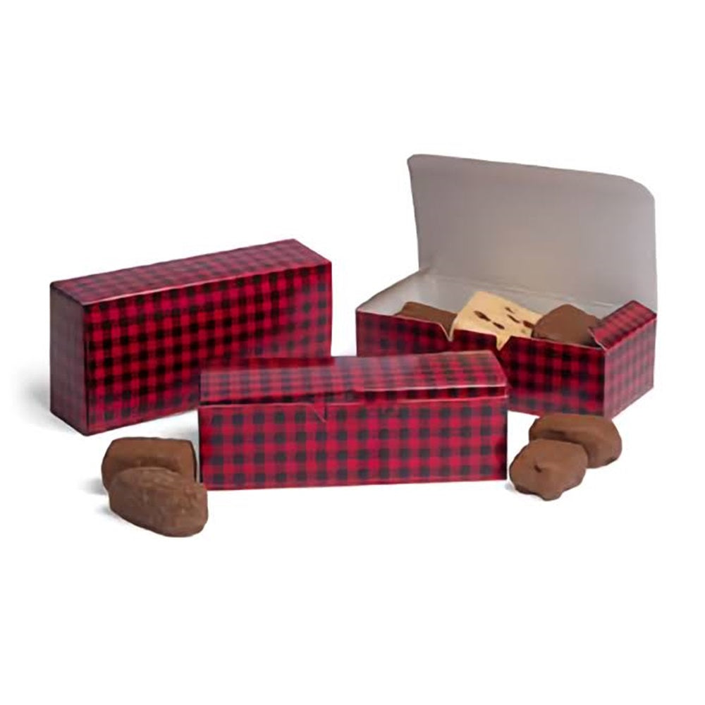 This image depicts a one-pound candy box with a buffalo plaid design in shades of red and black. The box appears to be made of sturdy material and is suitable for holding a variety of confectionery items. The lid of the box is open, revealing what seems to be a white interior, and a few chocolate candies are scattered in front, suggesting the box's use for sweet treats.