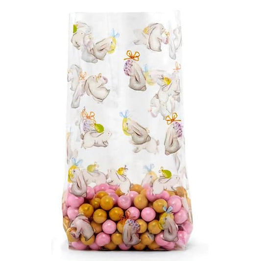 A clear cello treat bag printed with easter themed bunnies and eggs. The bag has a fresh spring feeling, and is filled with pink and burnt gold candies